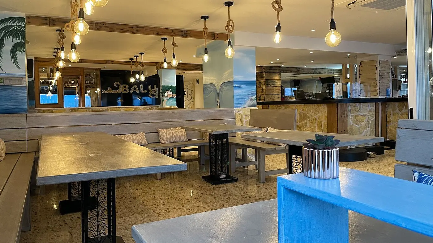 BALUS interior with wooden tables and blue seating