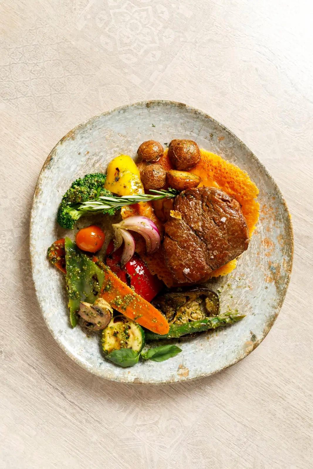 Grilled steak with potatoes and vegetables at ENCANTO