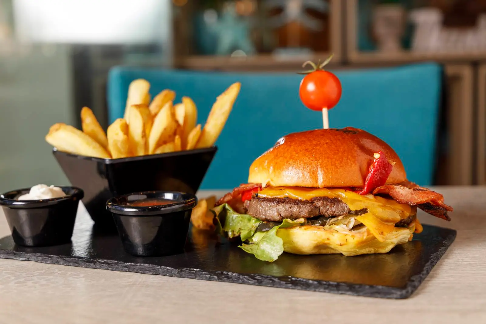 Bacon cheeseburger with fries at ENCANTO
