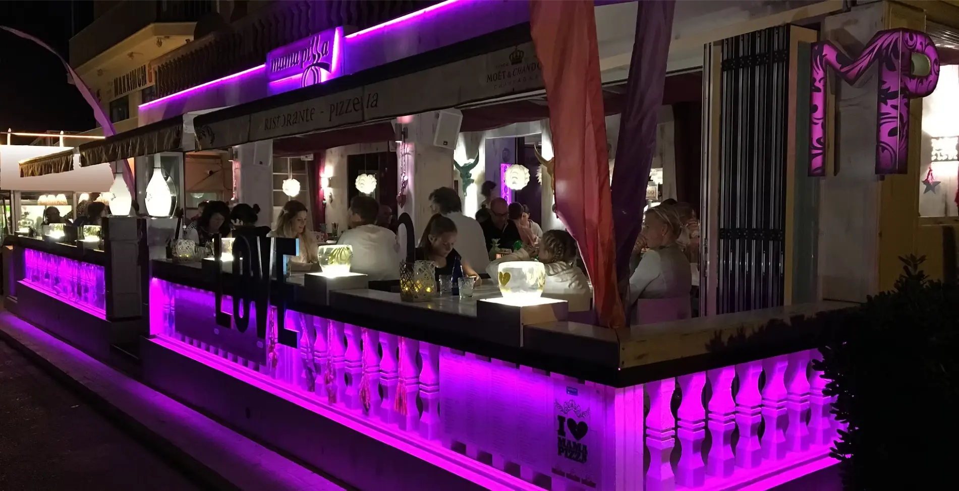 Mama Pizza terrace at night with purple lighting