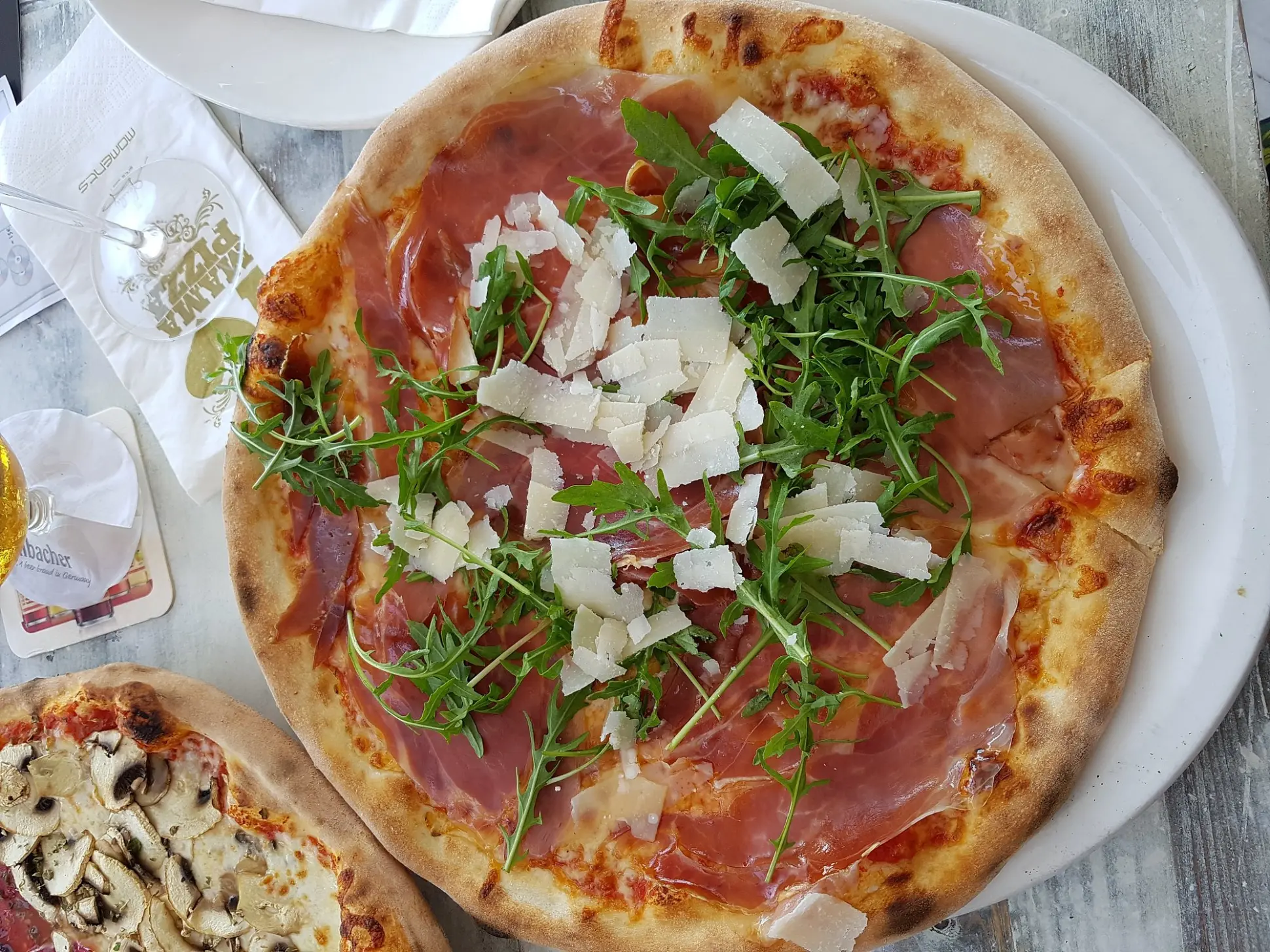 Pizza topped with rocket and shaved cheese