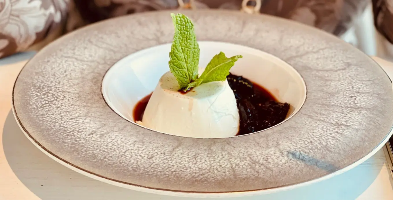 Dessert with fruit sauce and mint