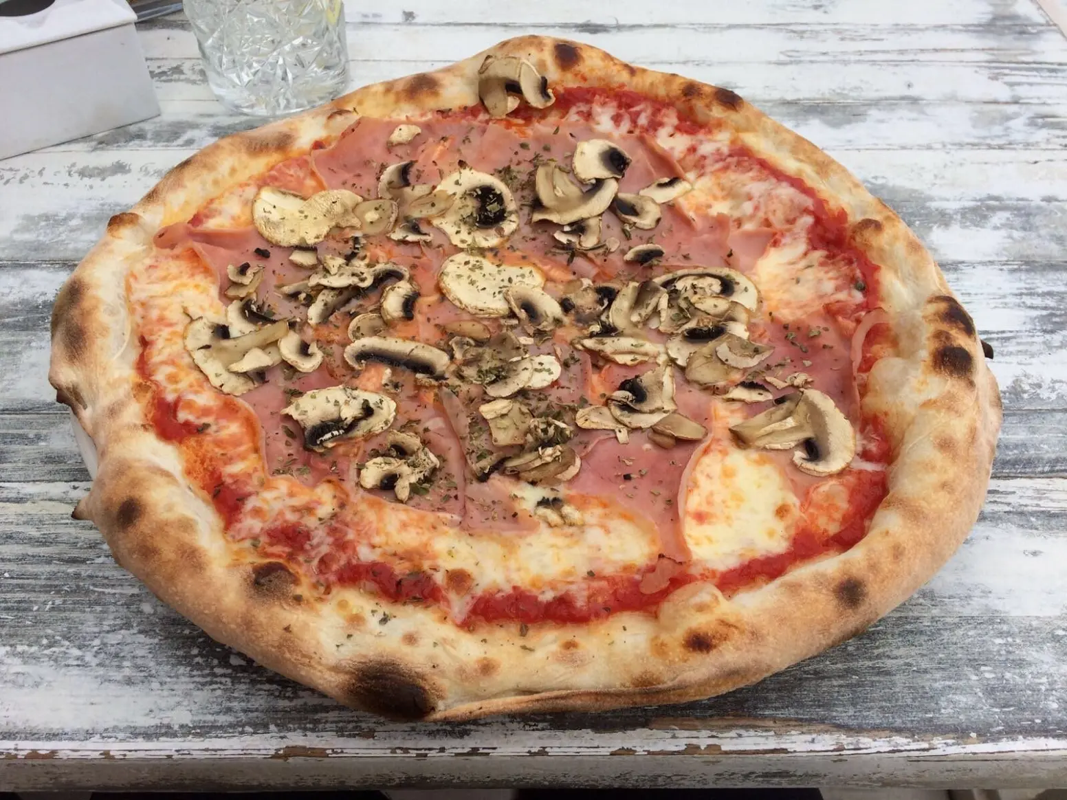 Mushroom pizza on a wooden table