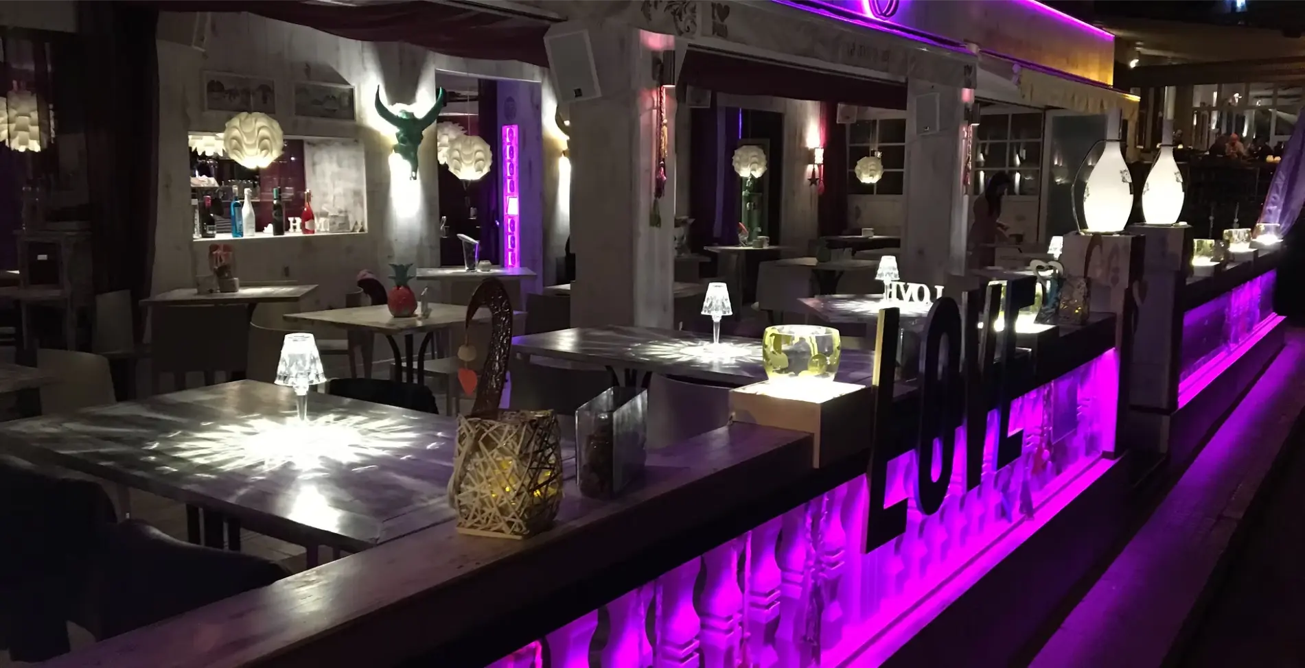 Mama Pizza terrace tables with purple lighting