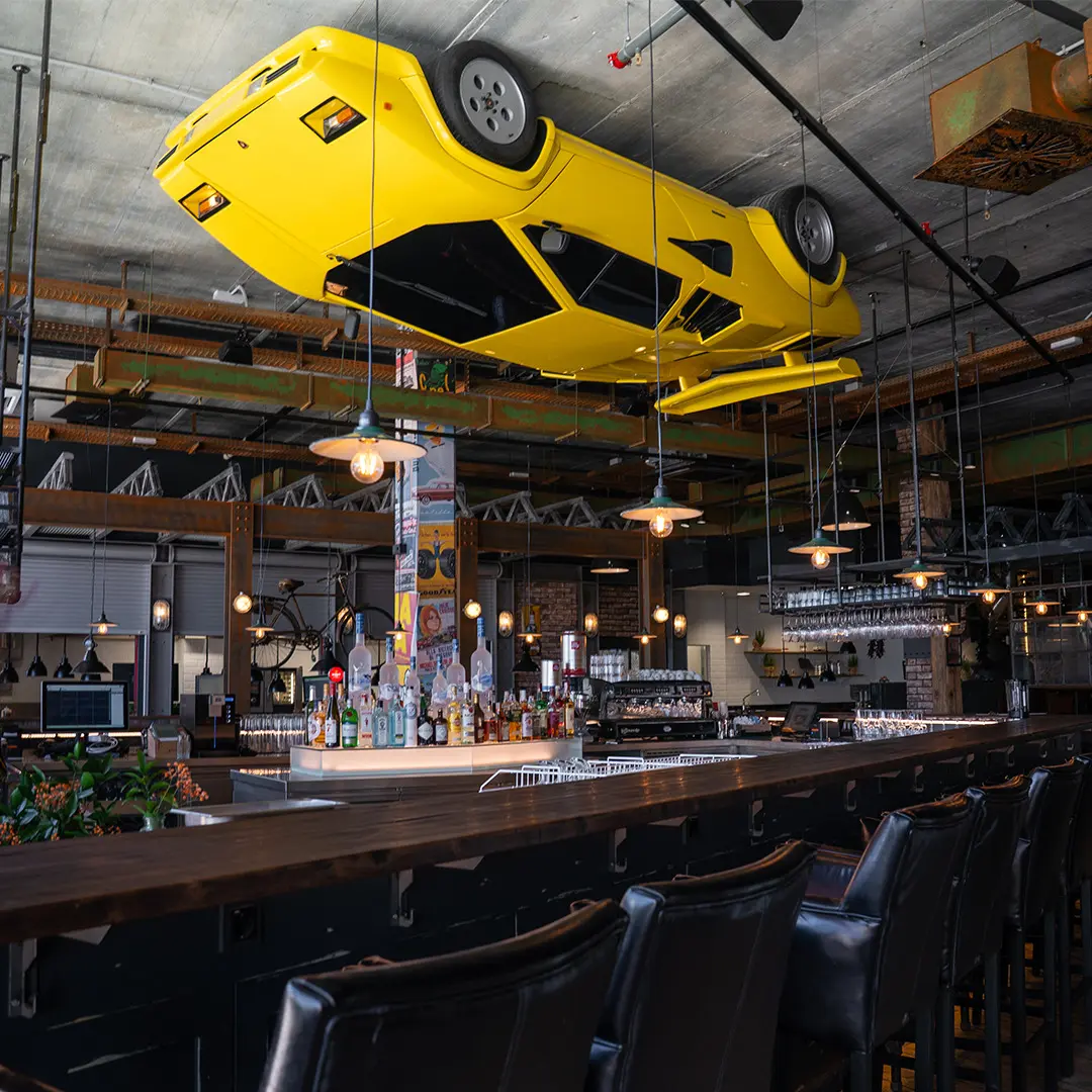 Yellow car suspended above the Motorworld bar