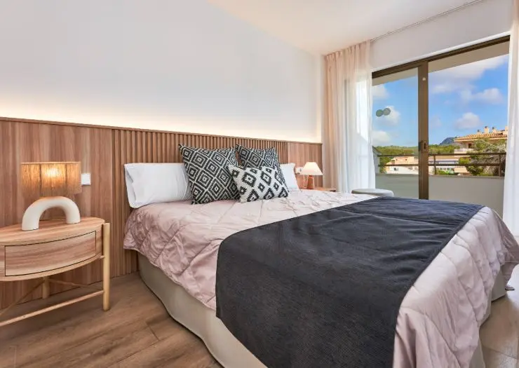 Apartment bedroom with a double bed and balcony