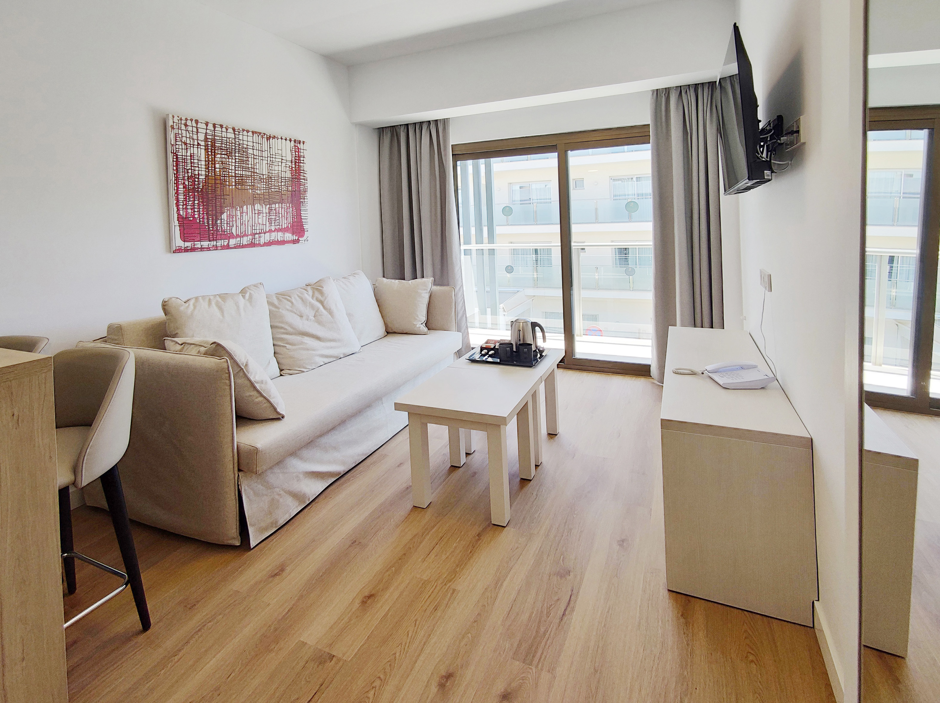Apartment balcony overlooking trees and neighboring buildings