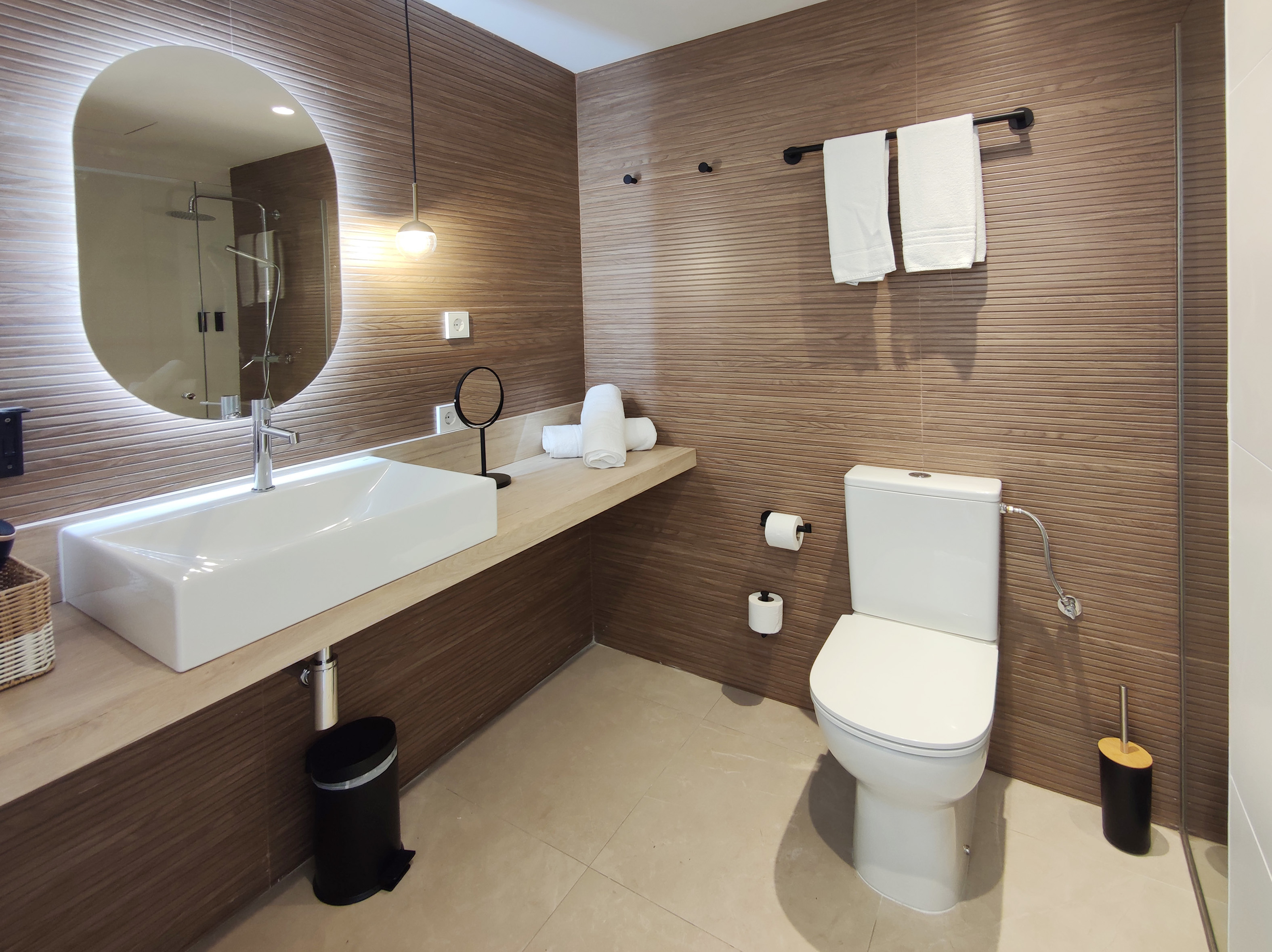 Modern Apartment bathroom with a walk-in shower and round mirror
