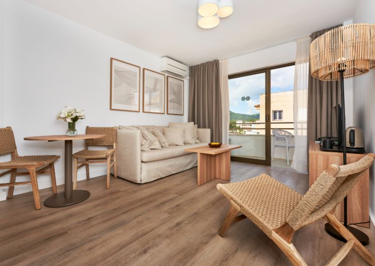 Apartment lounge with a sofa, dining table, and balcony
