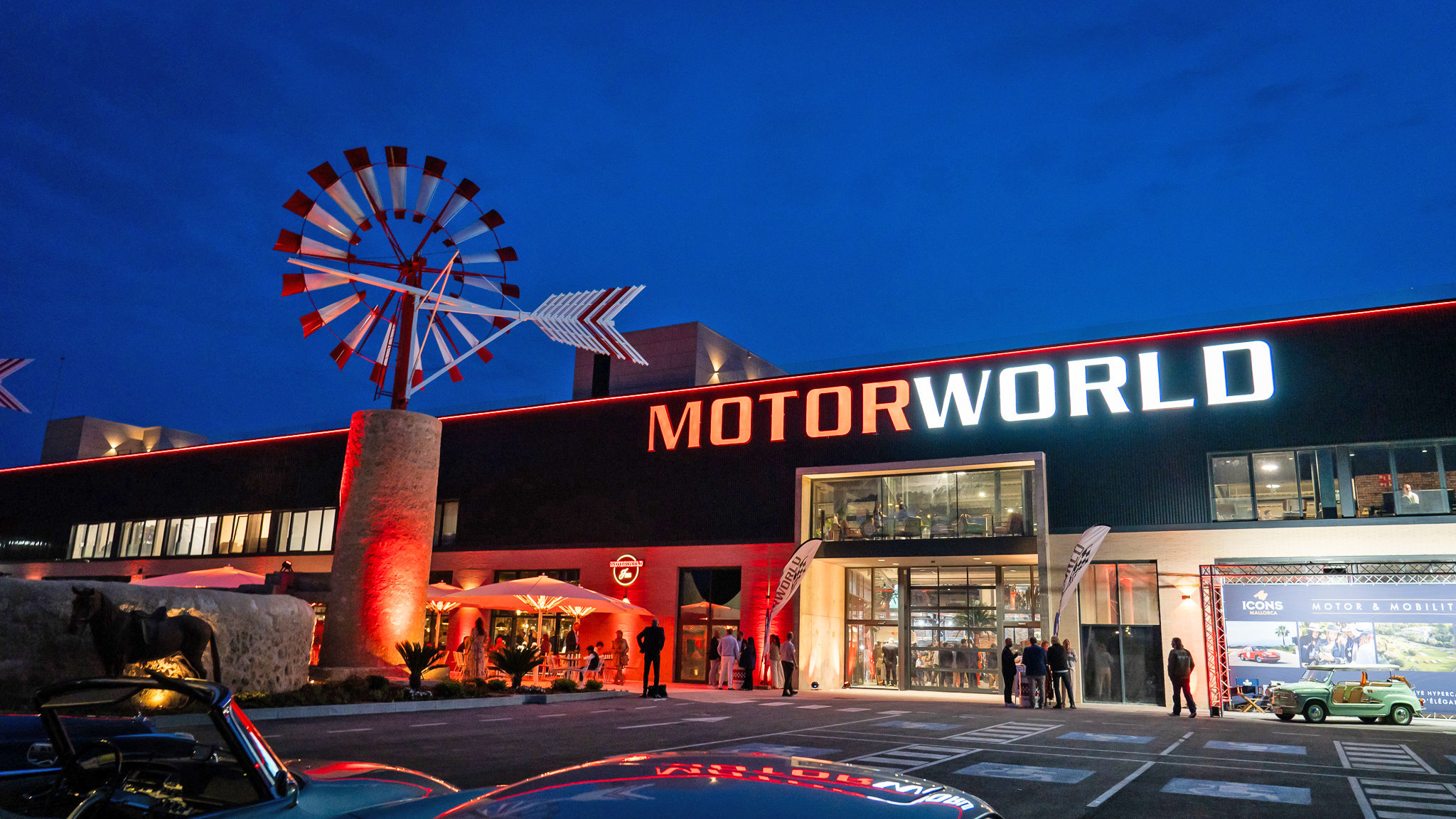 Illuminated Motorworld Mallorca entrance at dusk